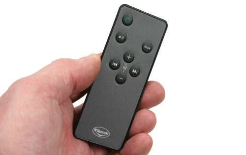 Hand holding a Klipsch iGroove SXT remote control