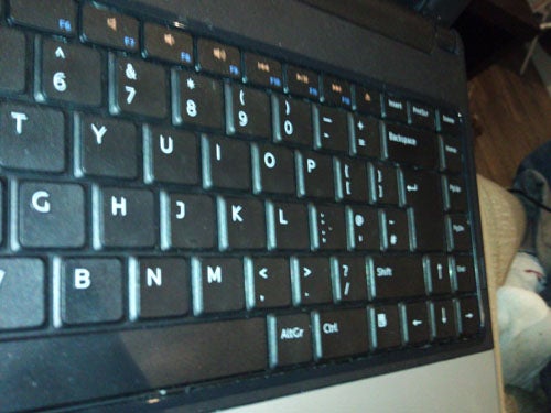 Laptop keyboard close-up during a review.