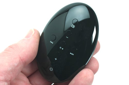 Hand holding Bowers & Wilkins Zeppelin Mini remote control.