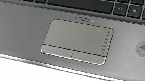 Close-up of HP Pavilion dm3 laptop trackpad and keyboard.