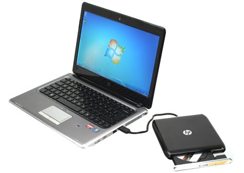 HP Pavilion dm3-1020ea laptop with external hard drive on desk.