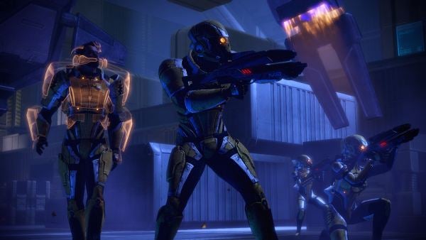 Characters from Mass Effect 2 in combat gear with weapons drawn.