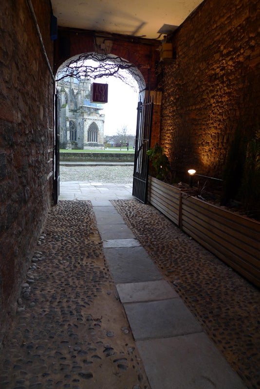 Stone passage leading to a historic church captured with Leica D-Lux 4.