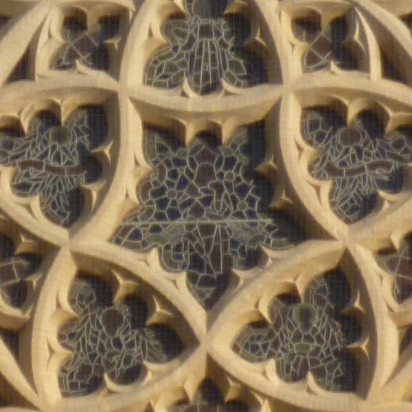 Close-up of intricate stone filigree patterns on a building.