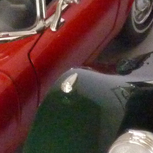 image of a red car with reflective surface.
