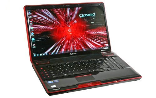 Toshiba Qosmio X500-10T laptop with red accents open on desk.