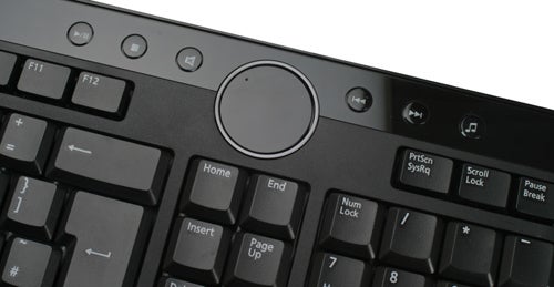 Close-up of Dell Inspiron keyboard with multimedia controls.