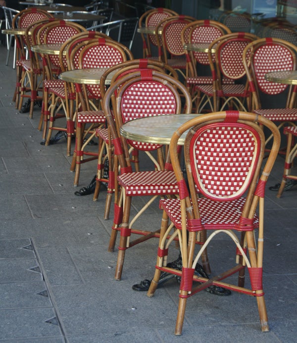Red and cream patterned bistro chairs in a row outside