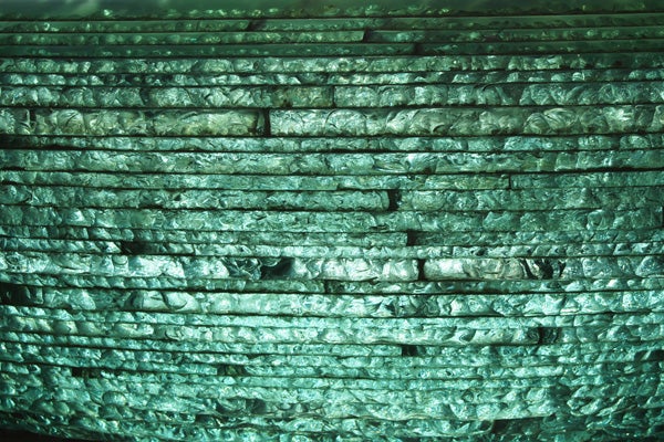 Close-up texture shot of green-tinted woven material.