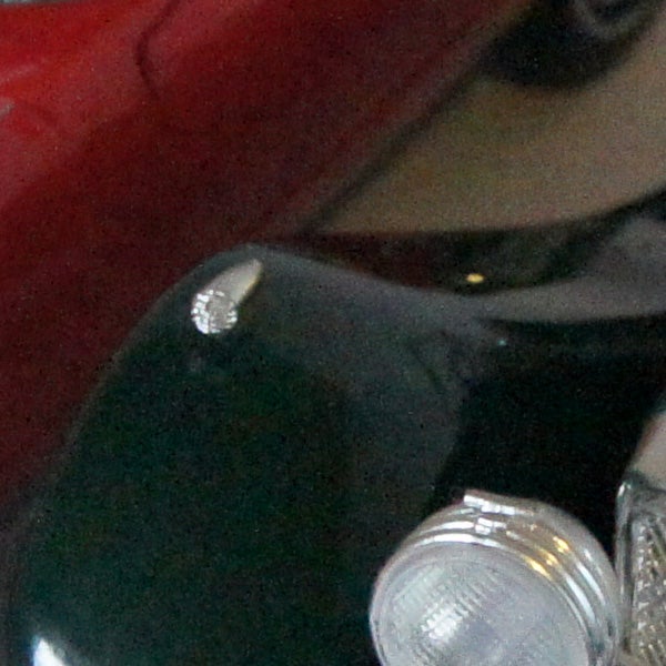 Close-up of a water droplet on a reflective surface.