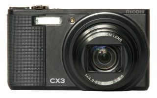 Ricoh CX3 digital camera front view with lens extended.