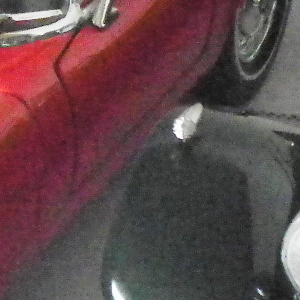 Low-light photo of a red car using Samsung WB5000 camera.