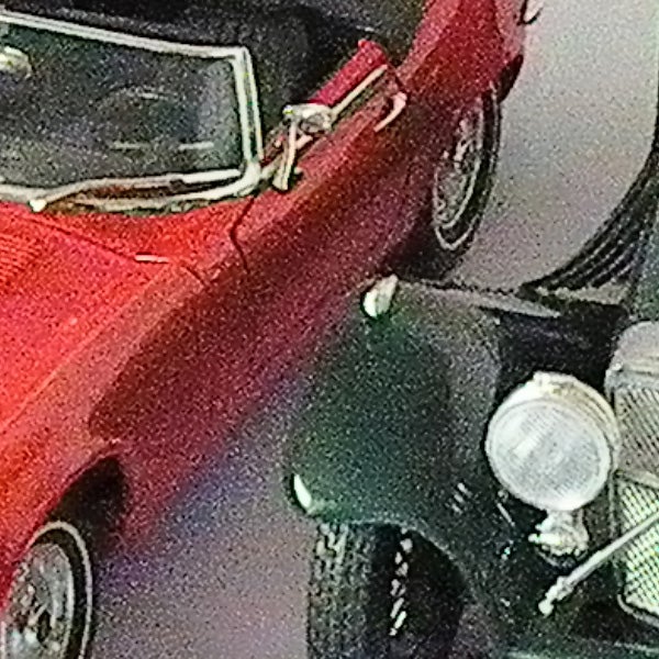 Low-resolution photo of red vintage car taken with Samsung WB5000.