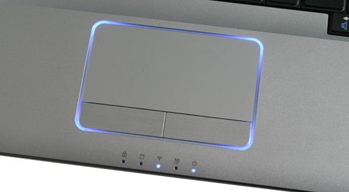 Close-up of Samsung R730 laptop's touchpad with blue illumination.