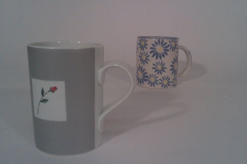 Two ceramic mugs with different designs on white background.