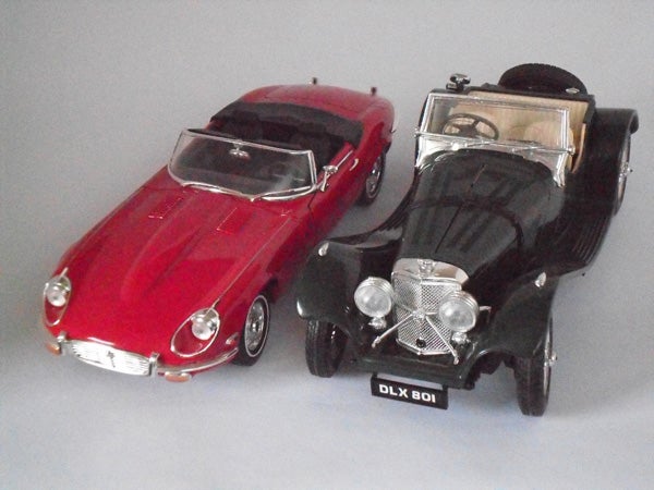Vintage red and black model cars on display.