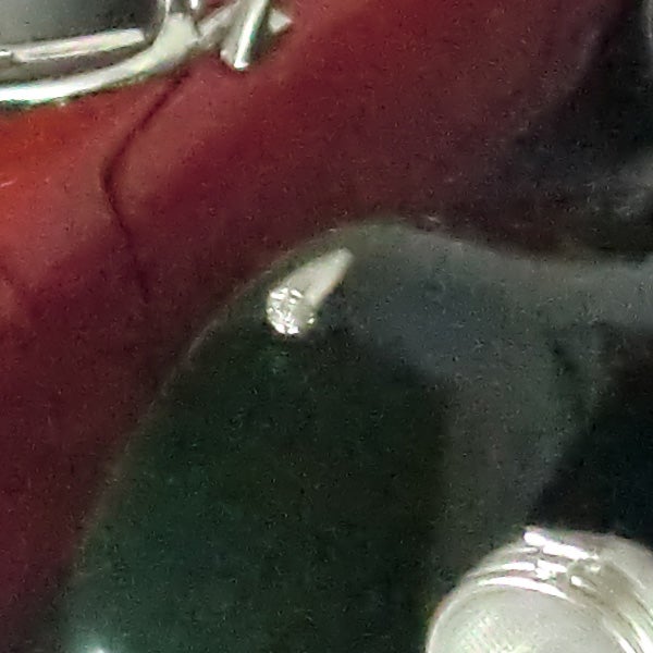 Close-up of a reflective surface with objects.
