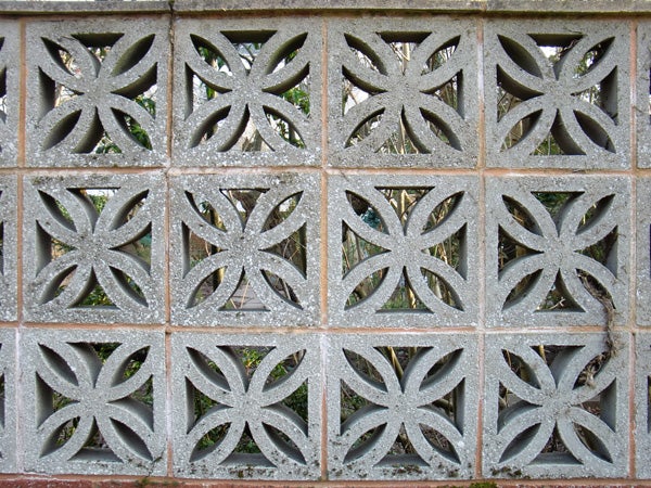 Decorative concrete block wall with geometric patterns.