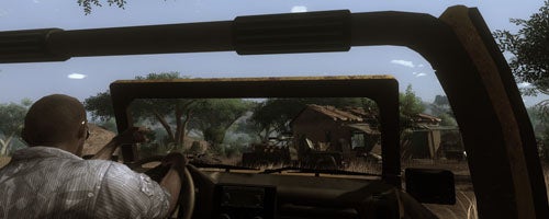 First-person view of a game scene driving through a village