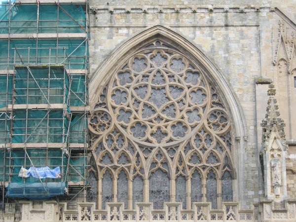 Detailed cathedral window with scaffolding on left side.