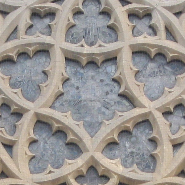 Decorative stone carving with intricate clover-like patterns.