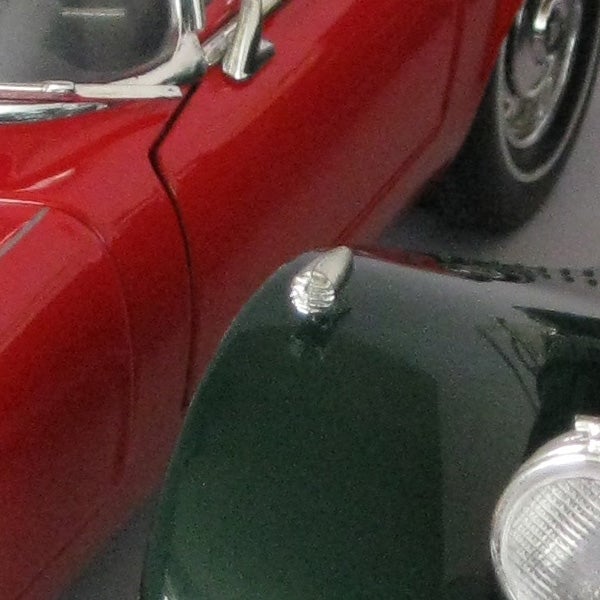 Close-up photo of red vintage car captured with Canon PowerShot A490.