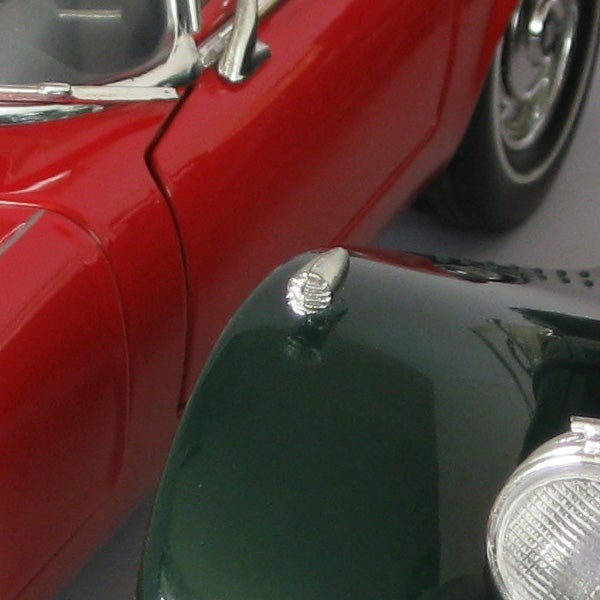 Close-up shot of red and green toy cars
