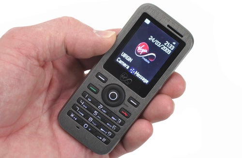 Hand holding Virgin Media VM621i (Alcatel OT-600) mobile phone.