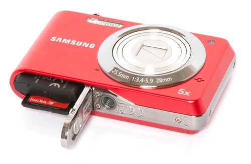 Red Samsung PL80 camera with battery compartment open