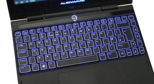 Alienware M11x laptop with backlit keyboard illuminated in blue.