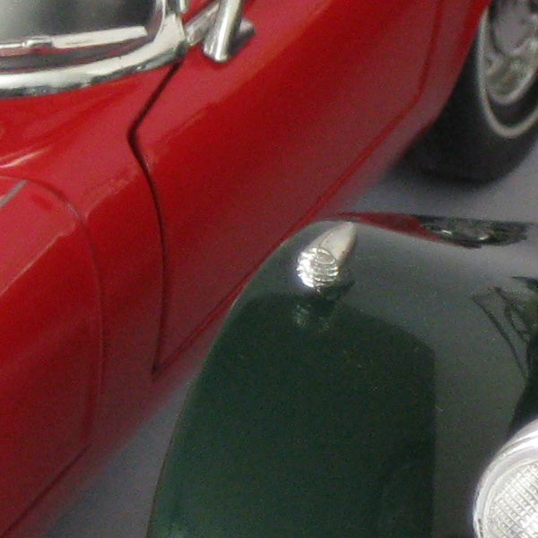 Close-up of a red car model captured by Canon PowerShot A3100 IS.
