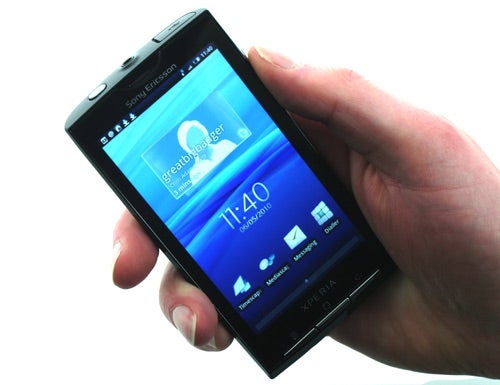 Hand holding a Sony Ericsson Xperia X10 smartphone.