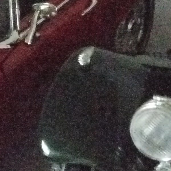 image of a motorcycle, poor low-light performance.