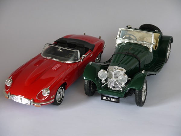 Scale model cars displayed side by side on a gray background.