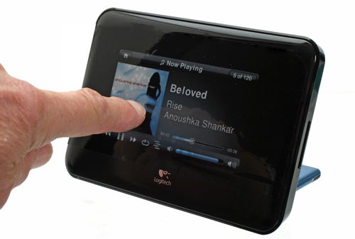 Person using Logitech Squeezebox Touch to play music.