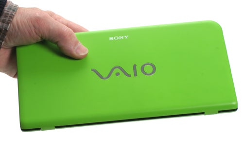 Hand holding a green Sony VAIO P Series laptop.