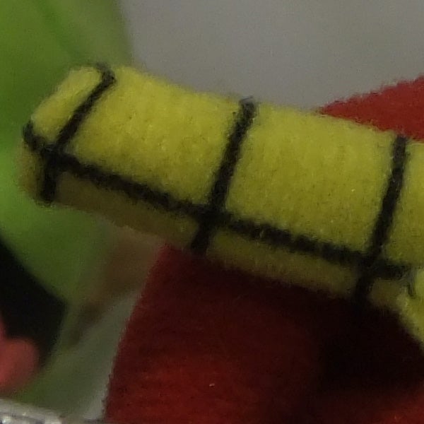 Extreme close-up of a yellow object with black lines.