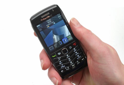 Hand holding BlackBerry Pearl 3G 9105 smartphone.