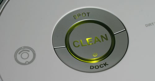 Close-up of iRobot Roomba's clean button illuminated.