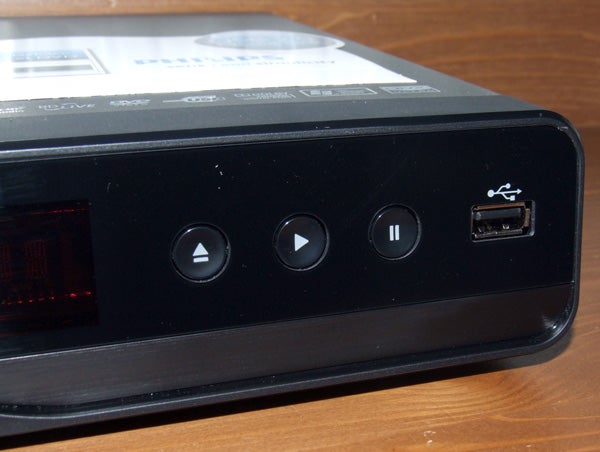 Close-up of Philips BDP3100 Blu-ray player's control buttons and USB port.