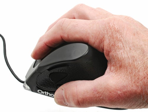 Hand holding an OrthoVia OrthoMouse with ergonomic design.