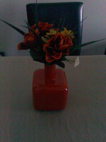 Flower arrangement in a red vase on a table