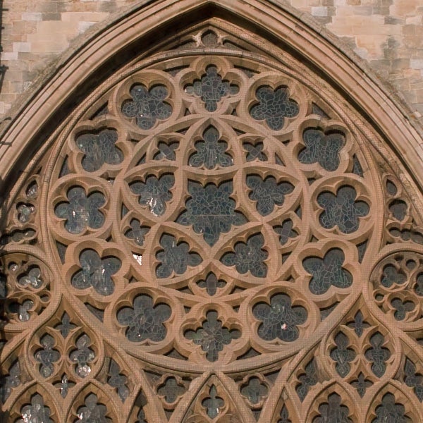 Close-up of intricate stone rose window architecture