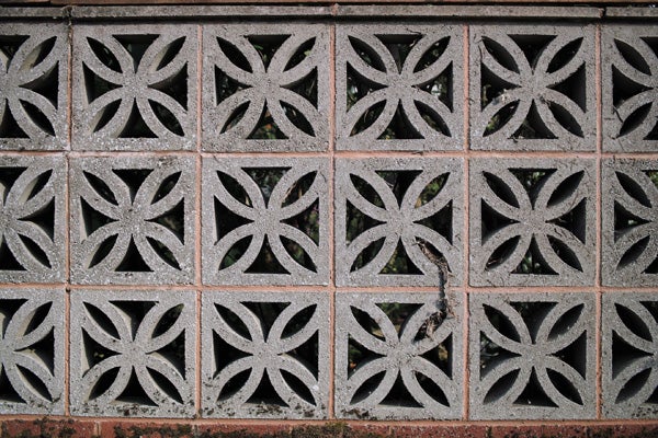 Decorative concrete block wall with intricate patterns.