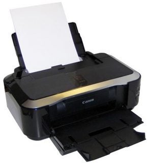 Canon PIXMA iP3600 inkjet printer with paper loaded.