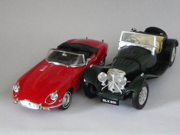Two model cars photographed with a gray background.
