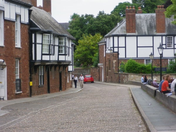 Photograph of a cobblestone street with Tudor-style buildings
