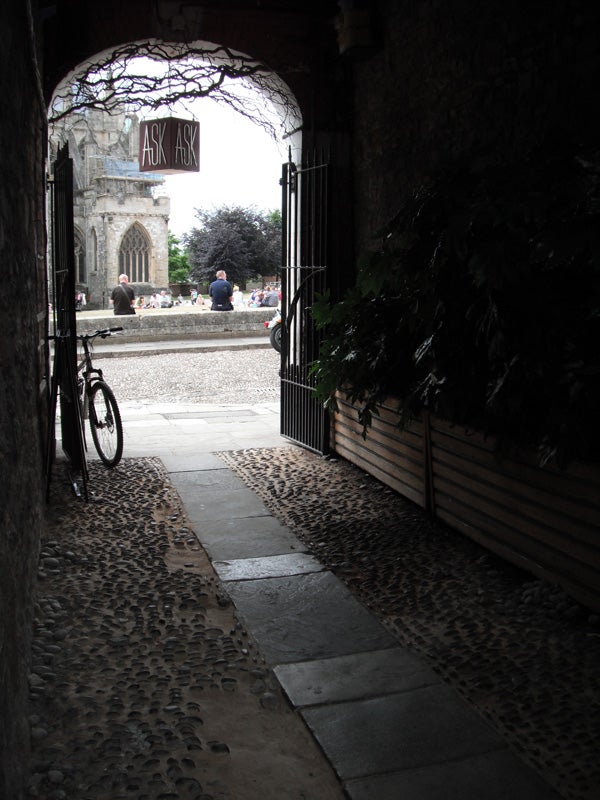 Cobbled alleyway view with bike leading to city square