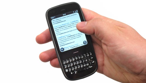 Hand holding a Palm Pixi Plus smartphone showing screen.