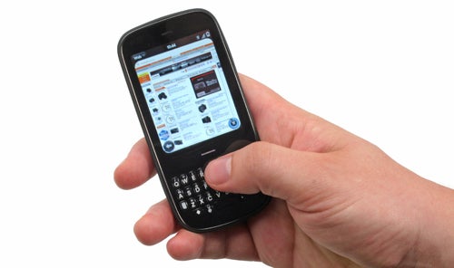 Hand holding a Palm Pixi Plus smartphone with screen on.